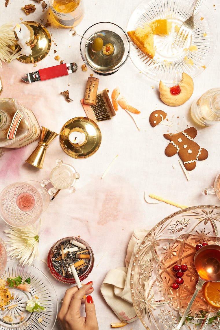 Holiday After party table with hand and cigarette by commercial food photographer Sarah Flotard  