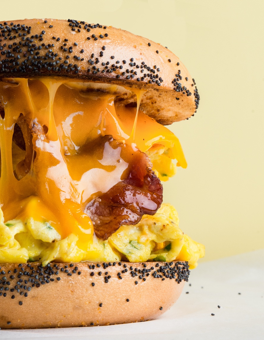 Breakfast sandwich with egg bacon and cheese on bagel commercial photography Sarah Flotard 